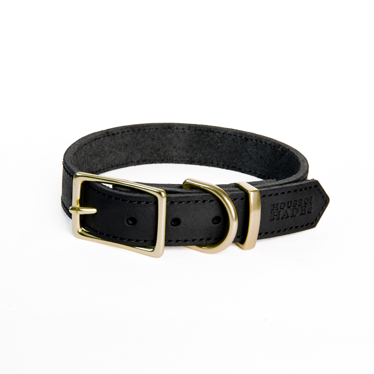 Black cowhide leather dog collar with warm brass rectangular buckle, D-ring and keeper, shown fastened in a loop. The smooth outer leather has visible black stitching and a House of Hades stamp on the pointed end. The inner side is soft and suede-like.