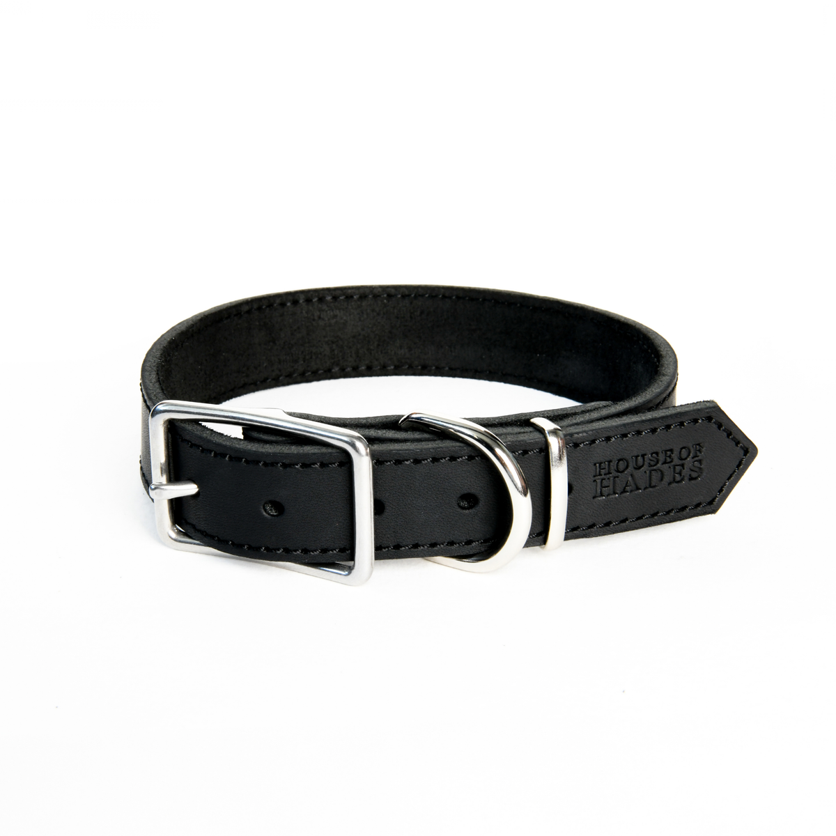 Black cowhide leather dog collar with cool silver-colour zinc alloy rectangular buckle, D-ring and keeper, shown fastened in a loop. The smooth outer leather has visible black stitching and a House of Hades stamp on the pointed end. The inner side is soft and suede-like.