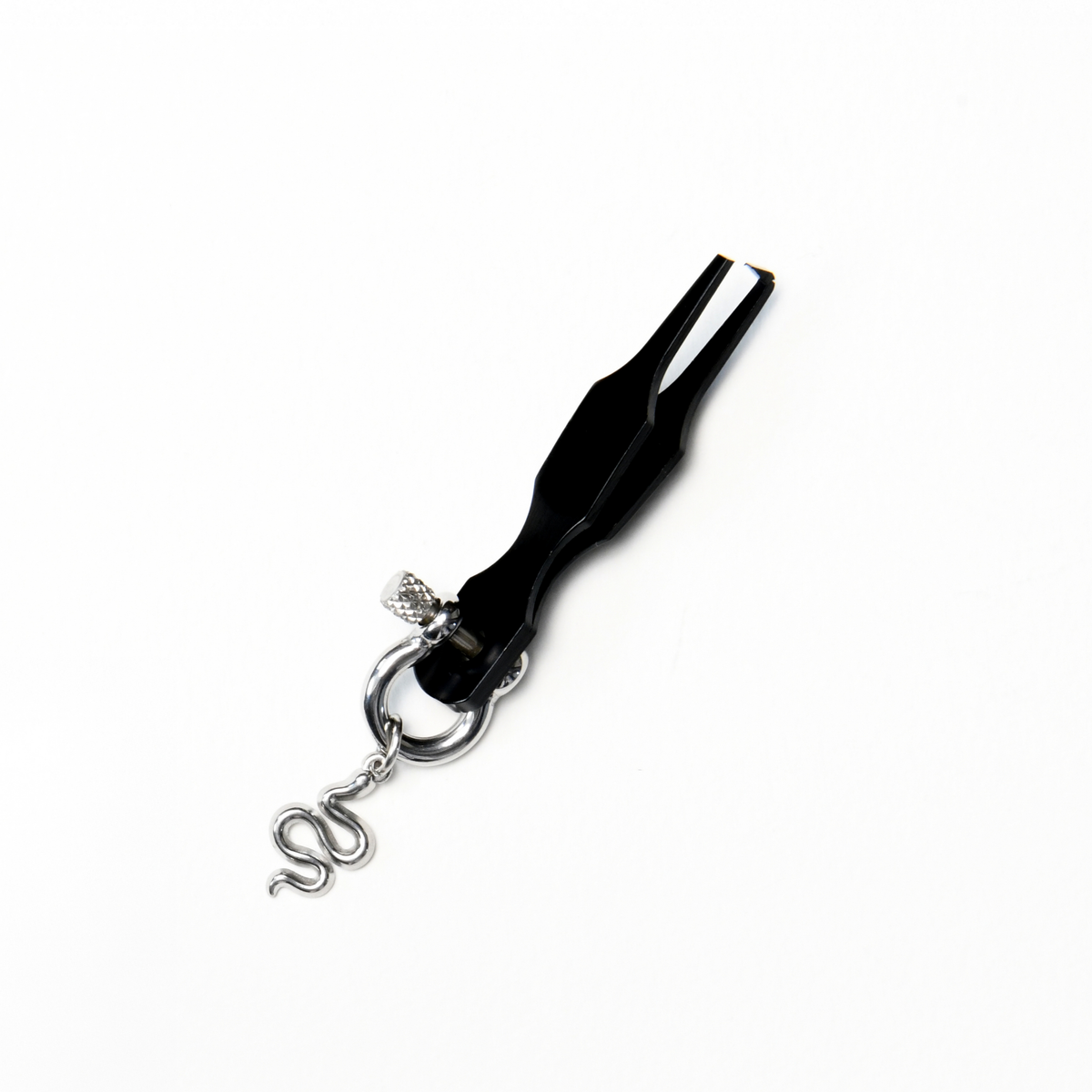 Black metal split ring opener shown from above, with a broad handle tapering into two narrow prongs for separating the coils of a split ring. Finished with a silver coloured horseshoe-shaped screw clasp and small snake charm hanging from the handle.