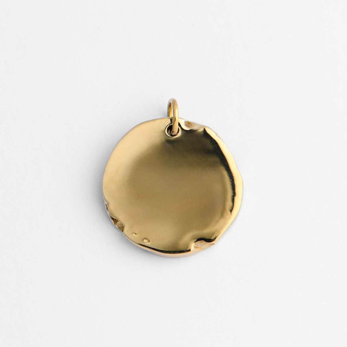 Back of Bolide in warm, golden-yellow brass, showing its smooth, plain reverse for personalised engraving.