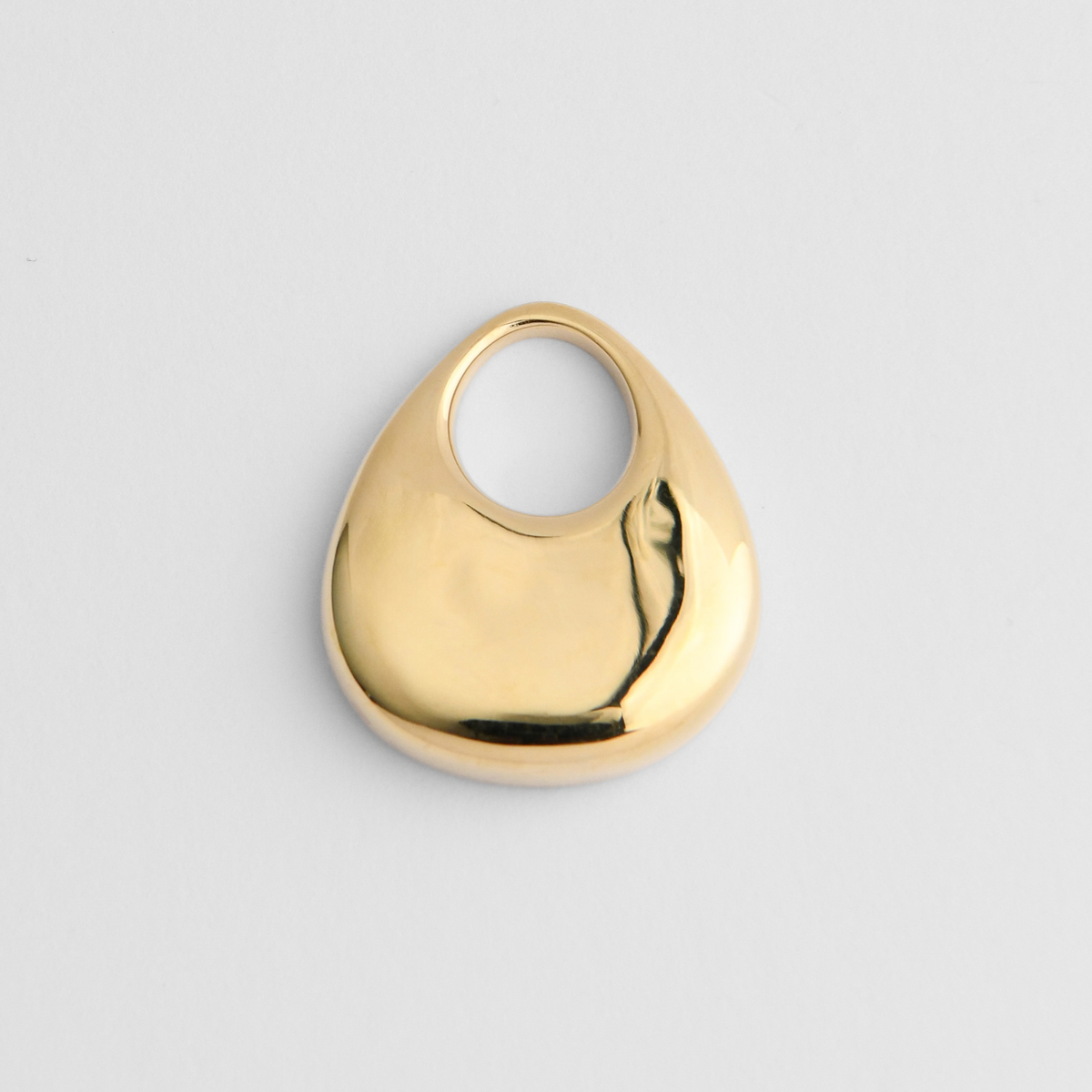 Argo, a smooth, bottom-heavy pendant in warm, golden-yellow brass, with a broad rounded base tapering towards a large circular opening near the top.