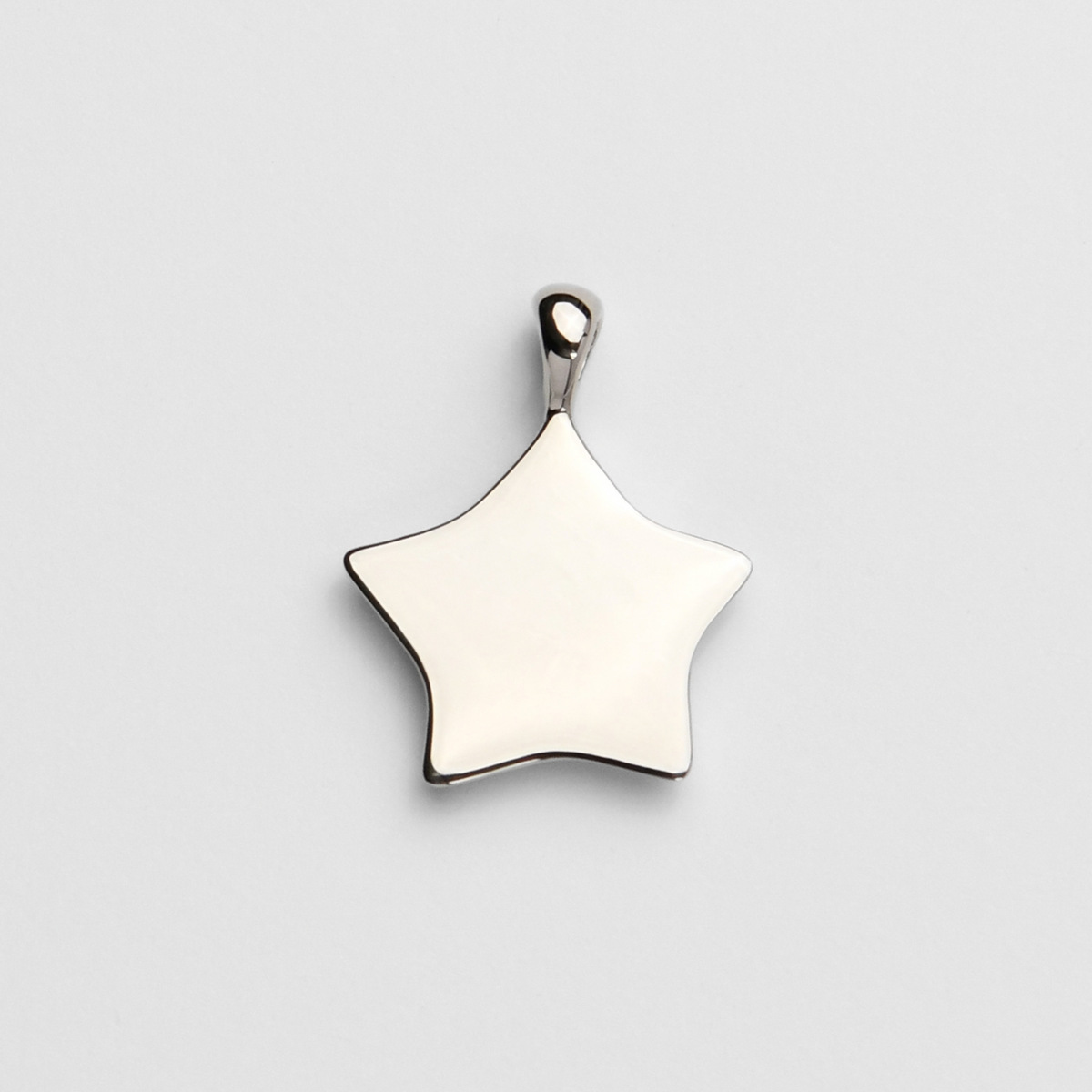 Back of Lyre, a five-pointed star pendant in cool, silvery white bronze, showing its smooth, flat reverse for personalised engraving.
