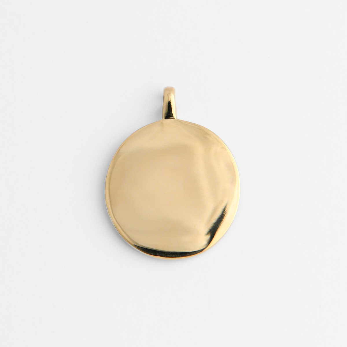 Back of Caligo in warm, golden-yellow brass, showing its smooth, plain reverse for personalised engraving.